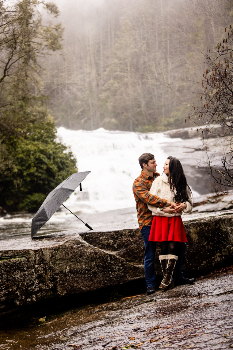 Engagement session with Triple Falls Waterfall in the background, outside Asheville, NC